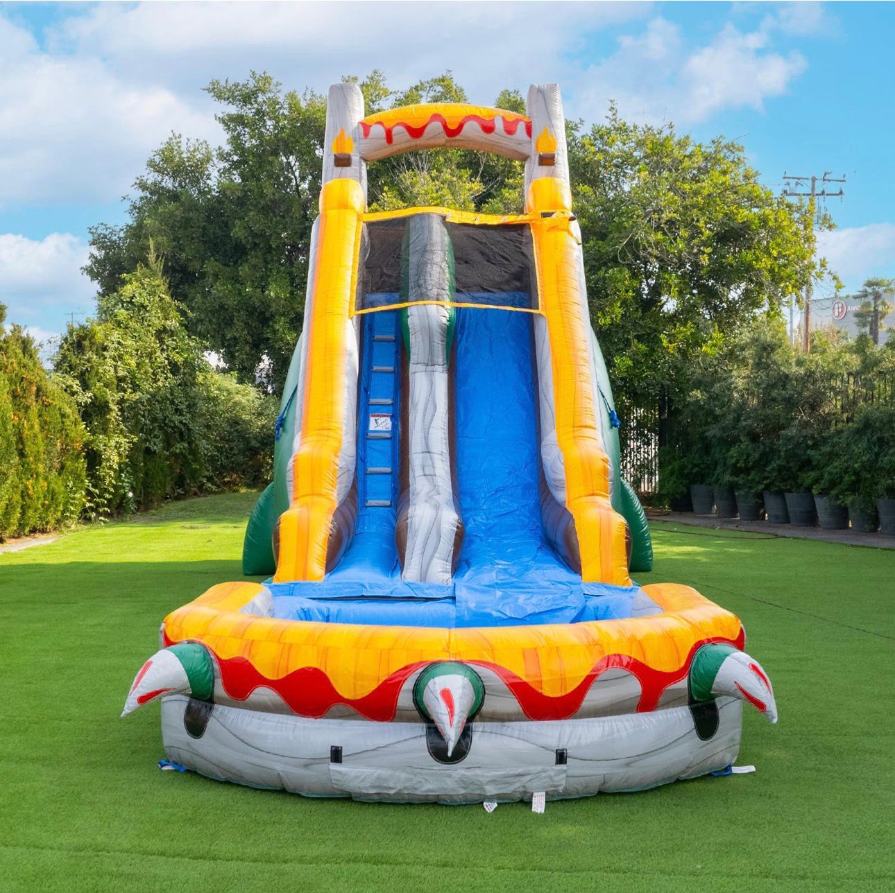 Front view of inflatable water slide rental — tall yellow and blue dragon-themed combo with pool available in Central Florida