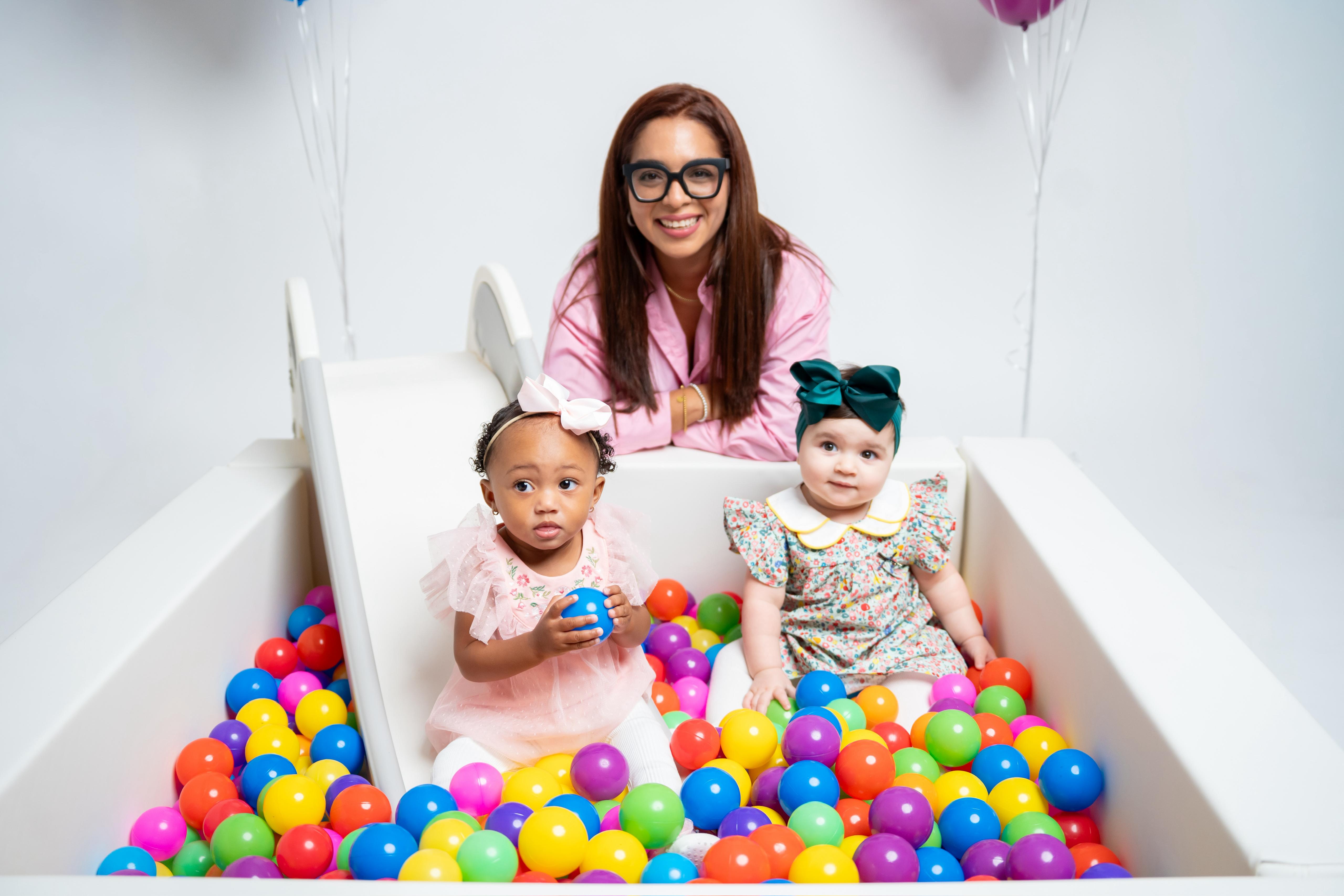 Pink themed soft play with ball pit and balloon arch — First Birthday party setup by Titi's Adventure